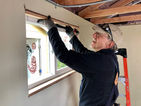 Longtime volunteer Dave fitting windows and trim at the developing T.C. Spirit village