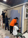 TOPS K-8 painting a tiny house during their Planting the Seeds service learning, immersion program
